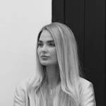 Graceful black and white portrait of a stylish woman with long blonde hair in London.